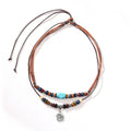 Turquoise wooden bead necklace with alloy geometric flower pendant on brown wax rope cord