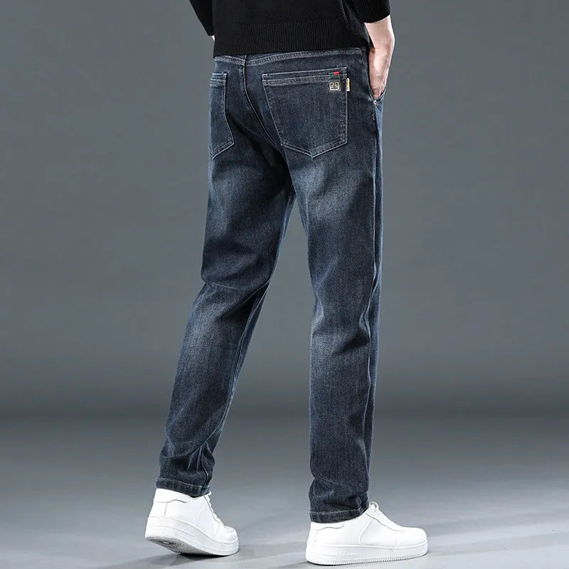 Blue grey slim straight casual trousers with a zipper fly on a mid-waist.