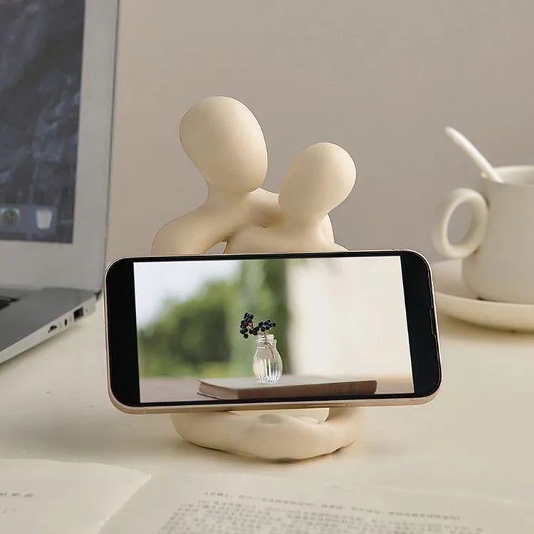 Modern minimalist loving couple resin statue in milky white or gold finish on wooden surface