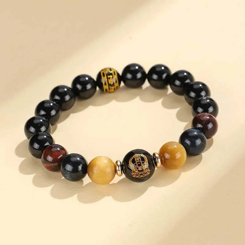 Handmade black agate beaded bracelet with gold, blue, and red tiger eye stones featuring Buddhist deity and zodiac animal motifs.