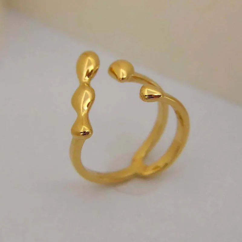 Brass ring with a spherical design on a circular band, shown in gold and silver finishes.