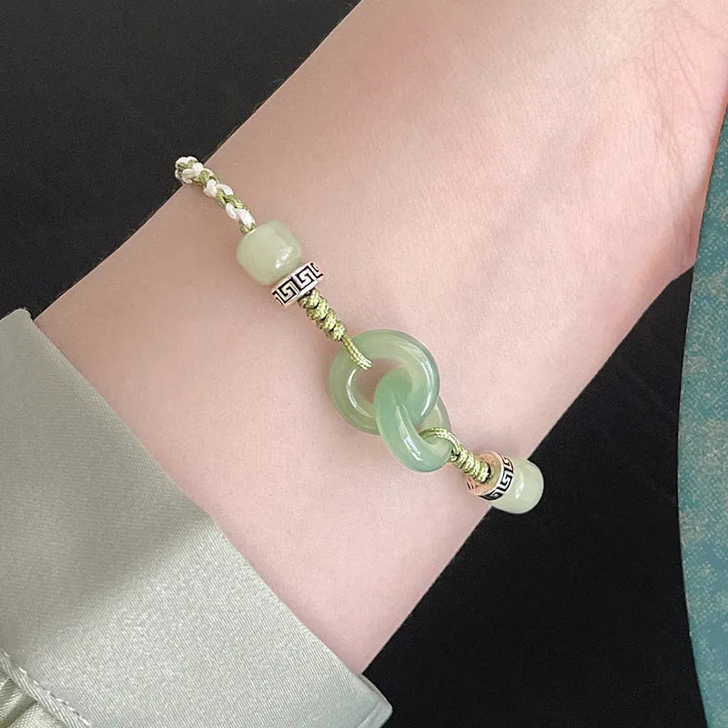Women's green and copper ethnic-style bracelet with jade buckle weaving and a peace buckle charm.