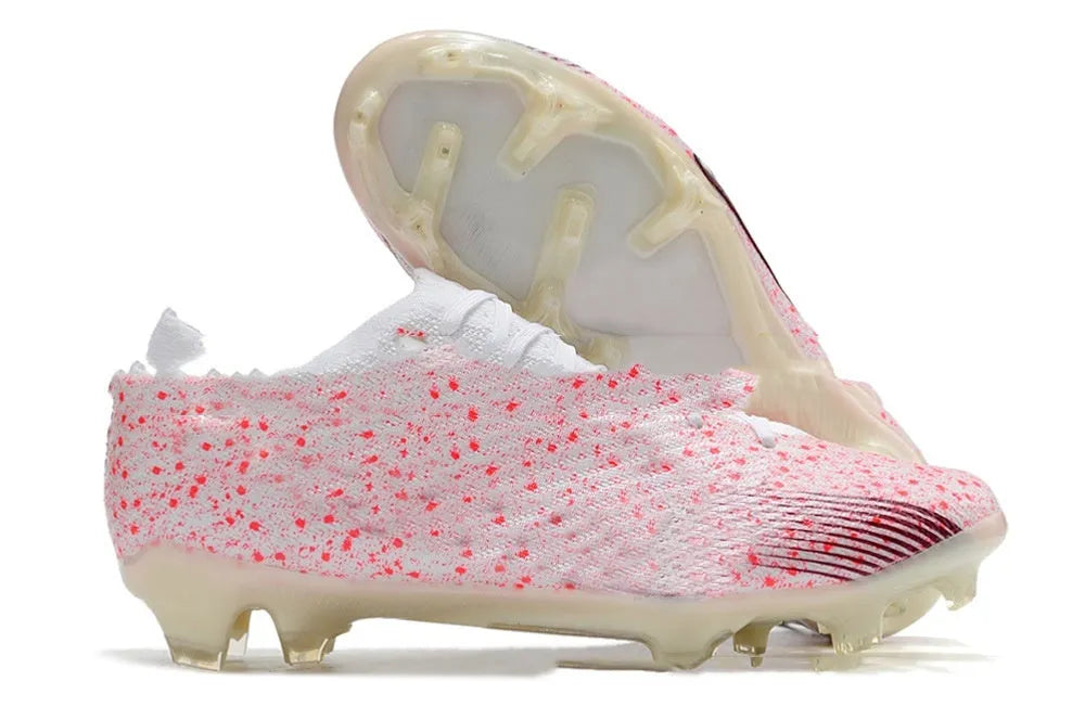 Men's low-top football shoes with knitted upper, FG studs, and a front lace-up closure.