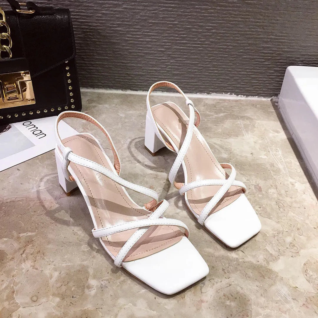 Women's thick heel Roman sandals in white colour showing backless design and side cutouts