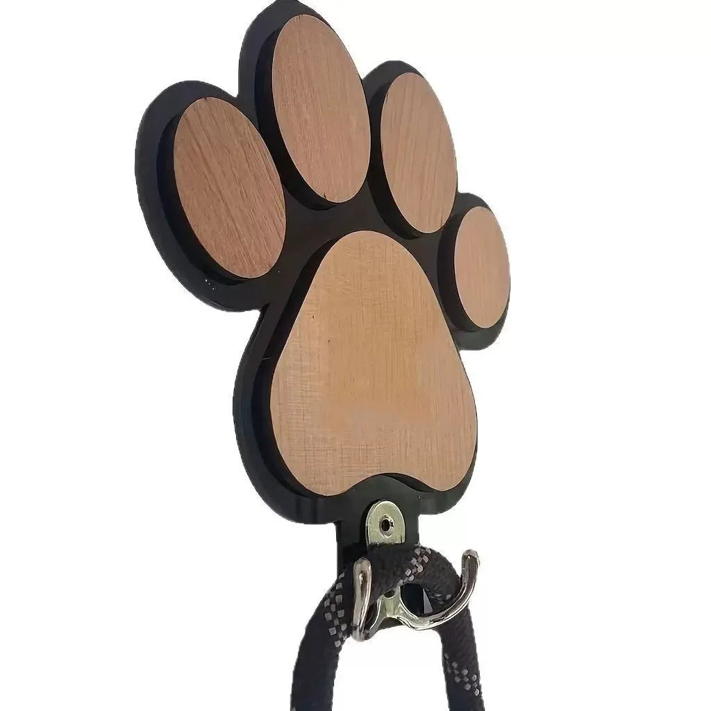 Wooden foot paw print wall hook in black on a white background, showing its shape and design.