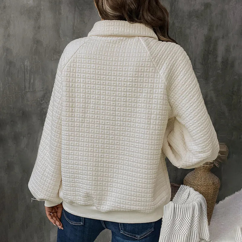 Women's solid colour polo collar sweater with long sleeves in a textured knit.