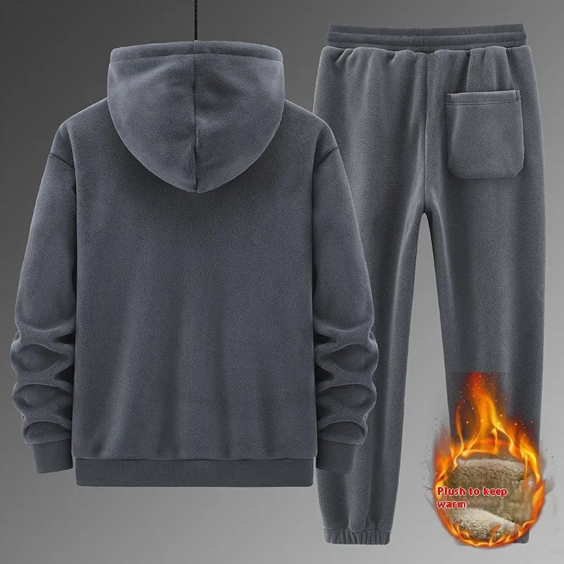 Grey hooded sweatshirt and matching trousers sports suit set laid flat
