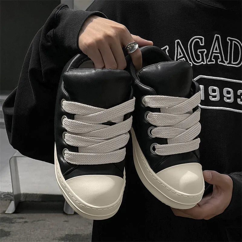 Men's black slip-on casual shoes with raised sole, leather uppers, and rubber soles showing round toe and shallow cut design