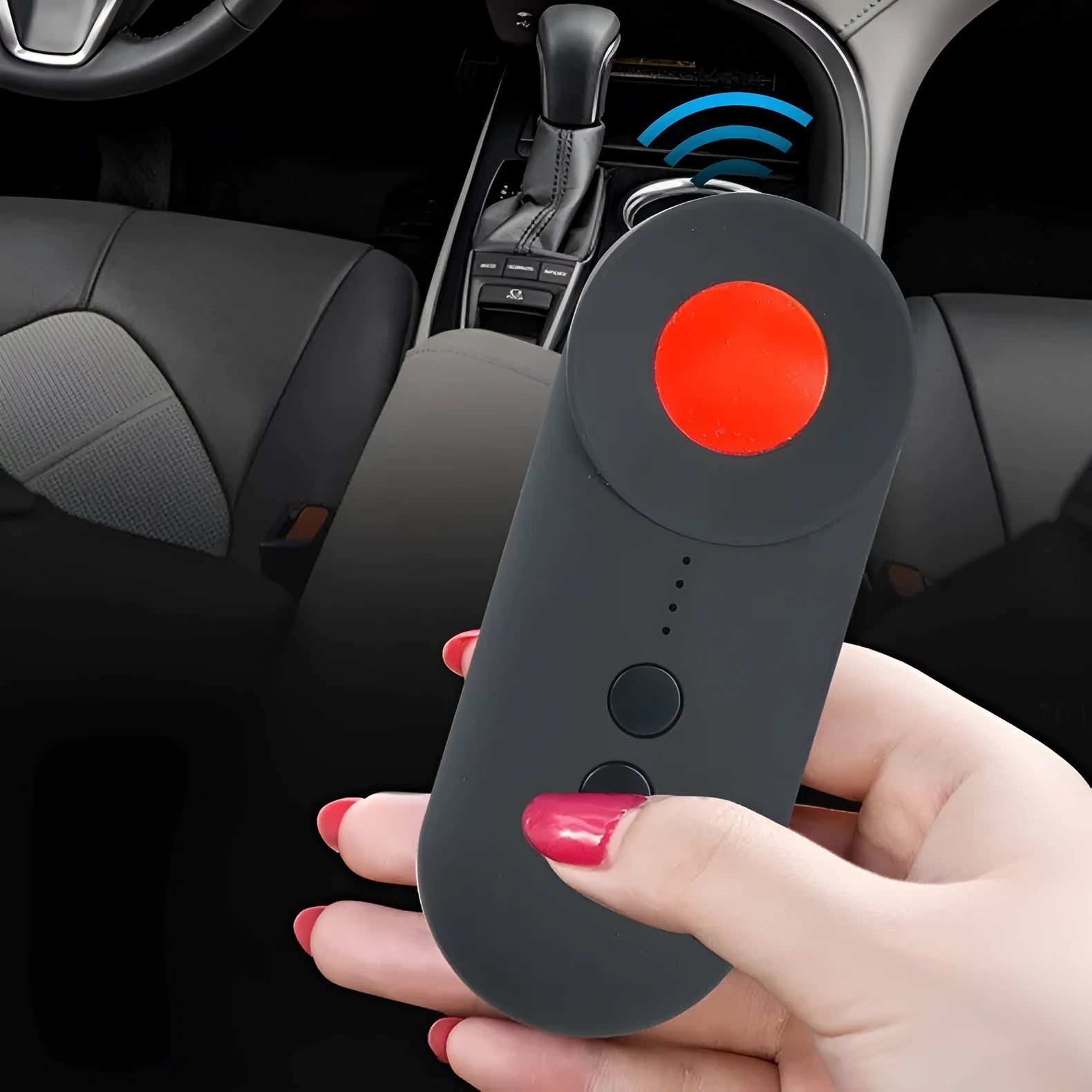 Black portable GPS and hidden camera detector with USB cable on a flat surface.