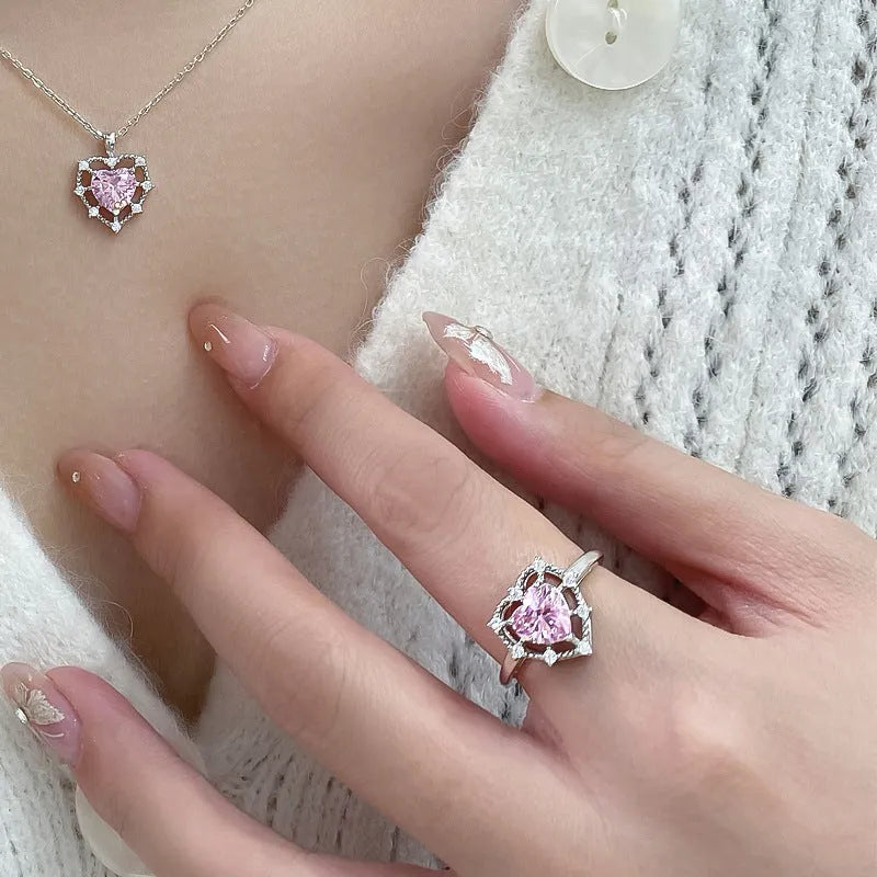 Silver heart-shaped ring with inlaid zircon and hollow-out band in white gold colour