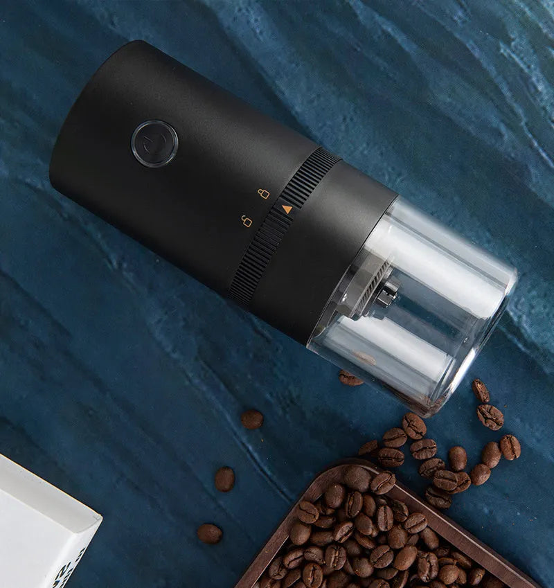 Portable black electric coffee grinder with transparent chamber and USB-C charging cable