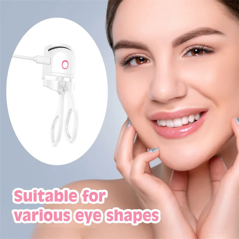 White and pink USB rechargeable heated eyelash curler with curved silicone pad.