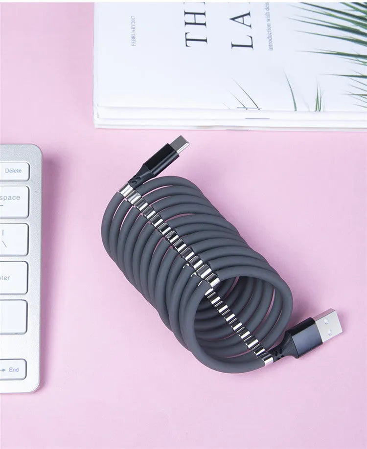 Black magnetic charging cable with multiple connector heads including USB-C, Micro USB and Apple-compatible 3.5mm