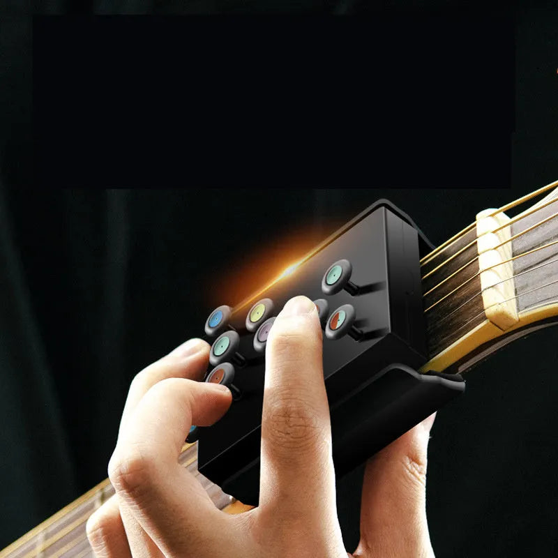 Black guitar finger trainer attached to a folk guitar fretboard