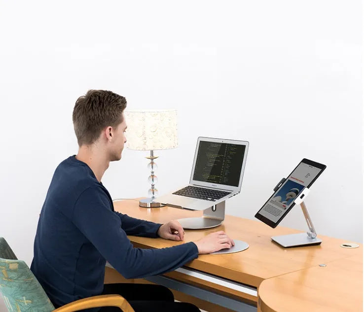 Foldable aluminium desktop stand holding a tablet at an angle.