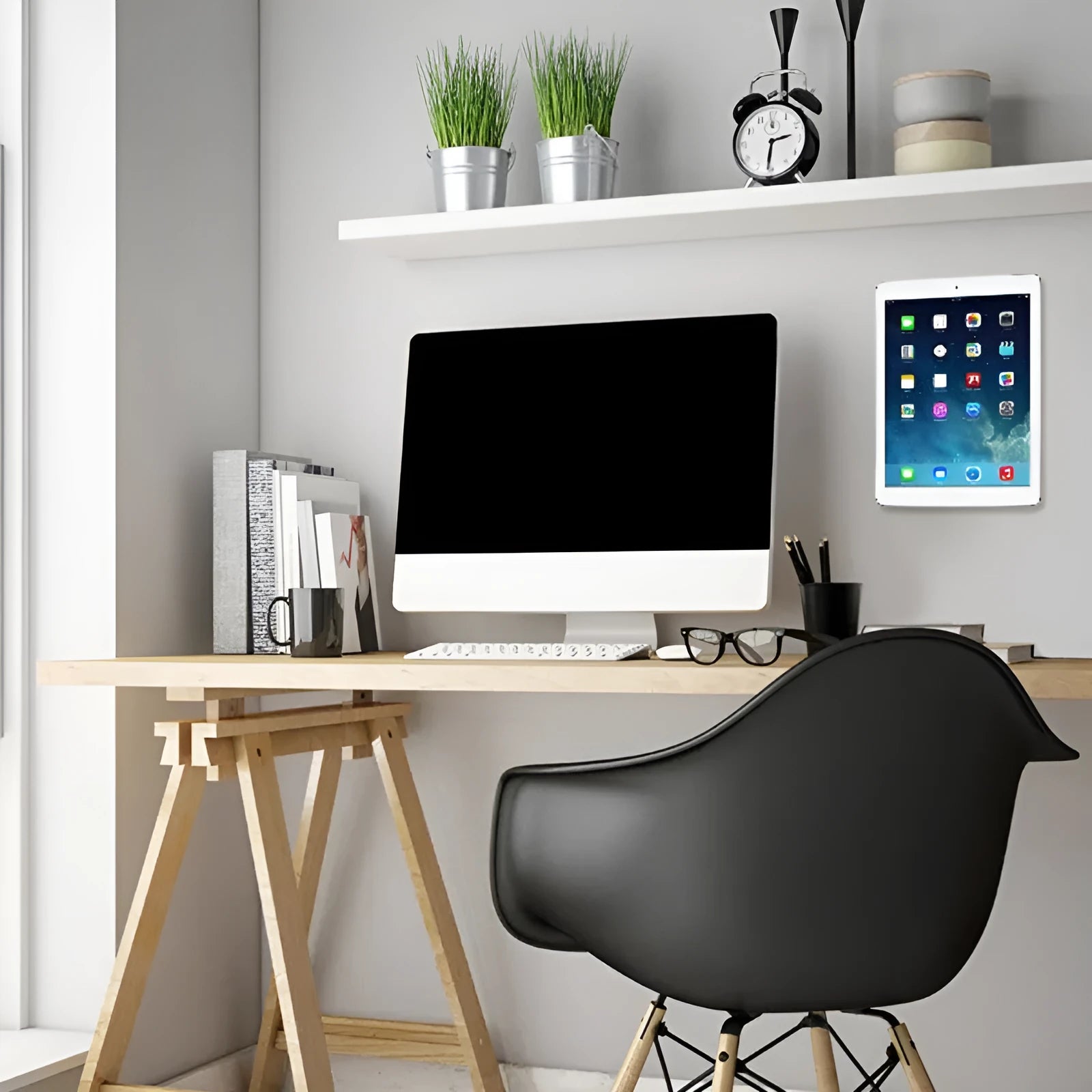 White magnetic tablet holder with adhesive base mounted on wall holding iPad