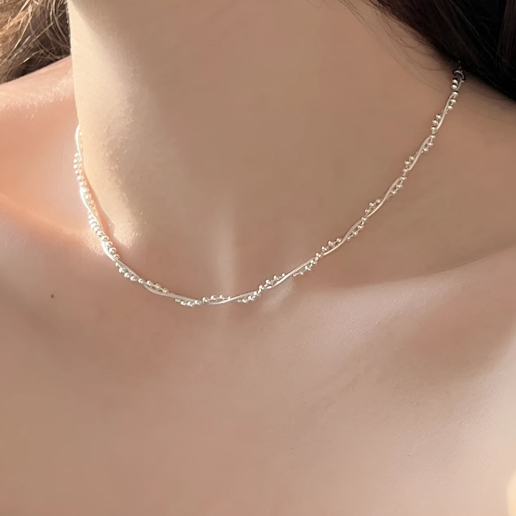 925 sterling silver geometric pendant necklace with electroplated silver finish on woman