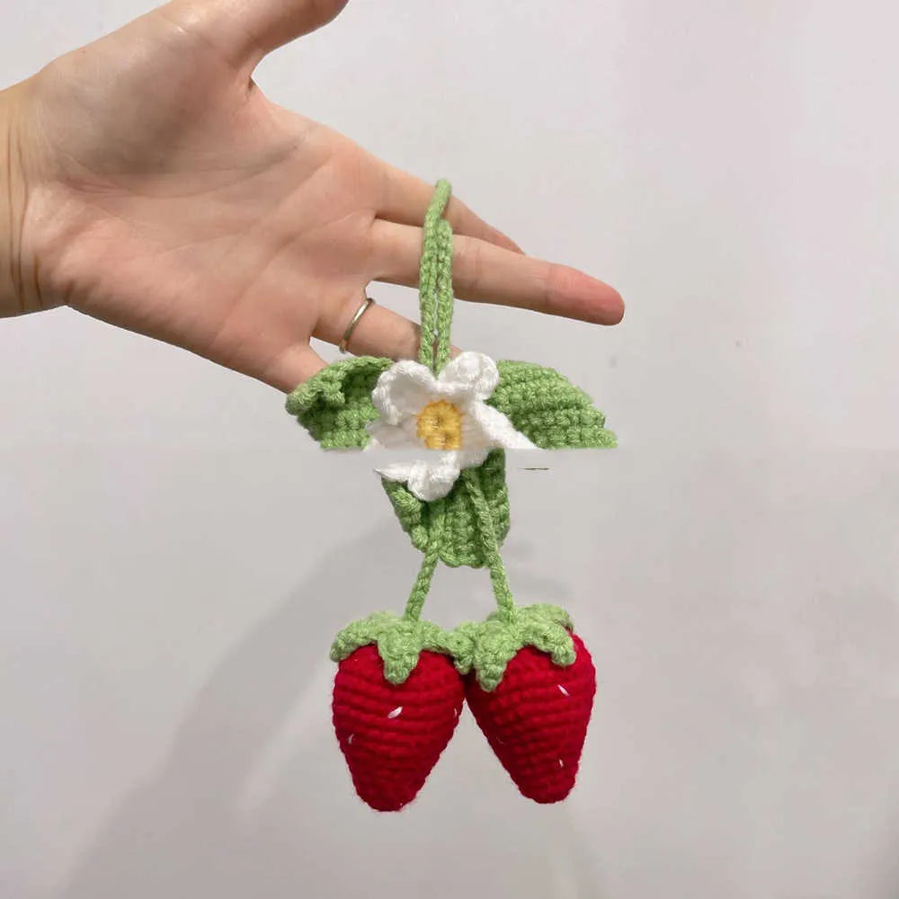 Handmade knitted strawberry-shaped car pendant made from cotton and hemp wool.