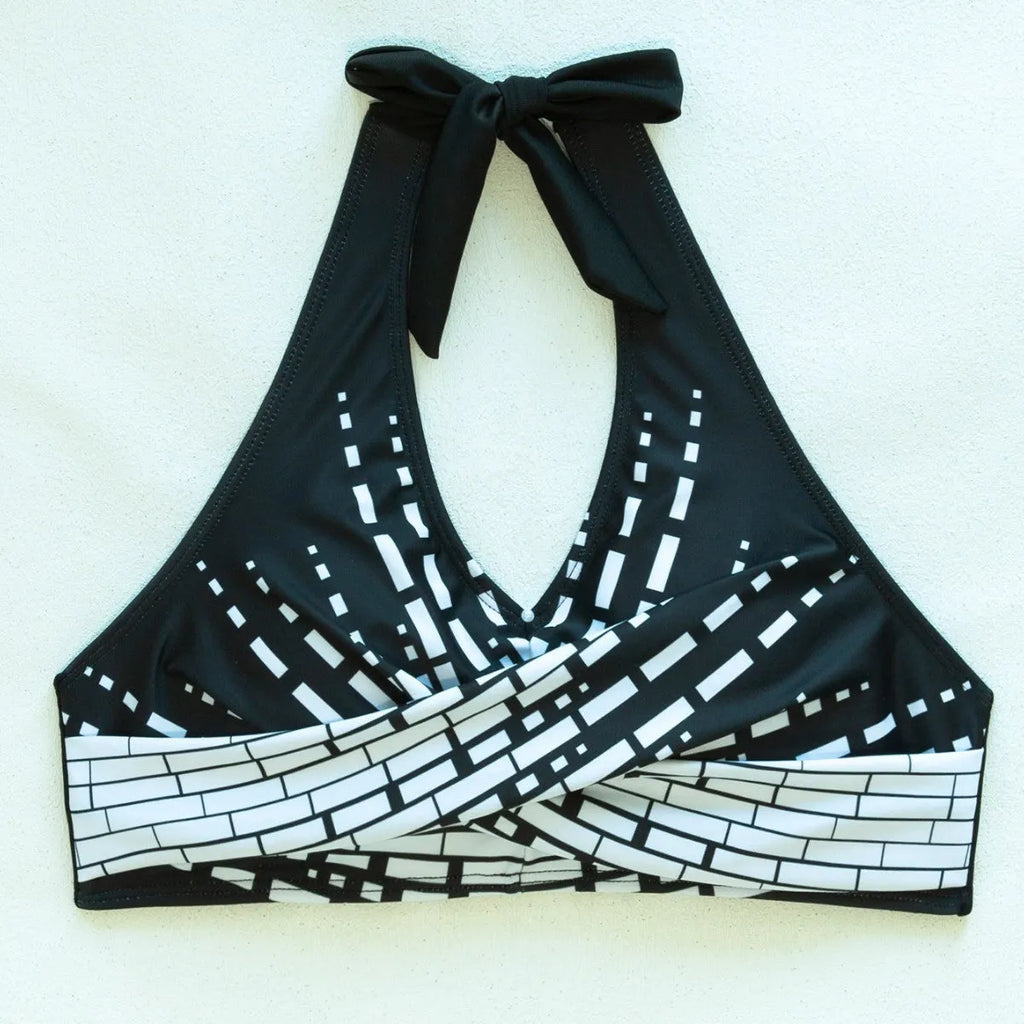 Women's two-piece swimsuit with halter high chest top, briefs-style bottoms, and matching shorts in contrast colour