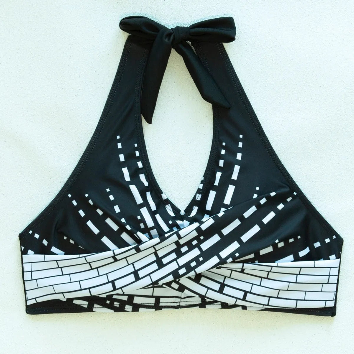 Women's two-piece swimsuit with halter high chest top, briefs-style bottoms, and matching shorts in contrast colour