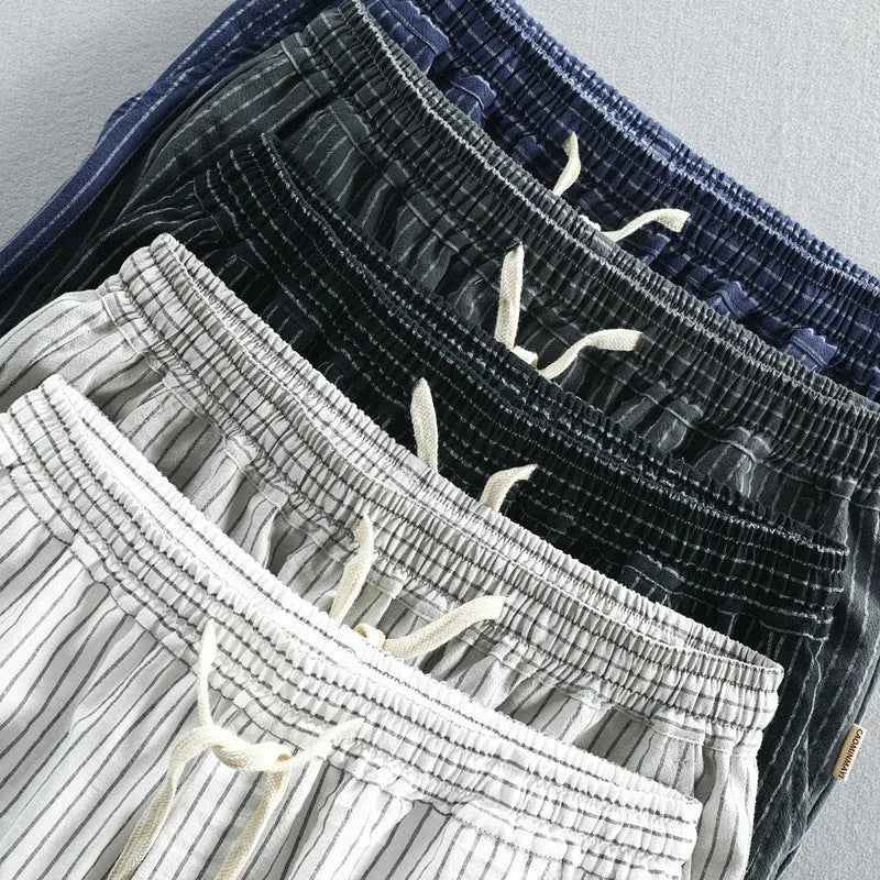 Men's striped loose-fit straight-leg casual shorts on a hanger.