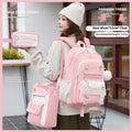 A girls' school backpack in Oxford cloth, featuring curved shoulder straps, shown in a choice of colours including pink, blue, and black.