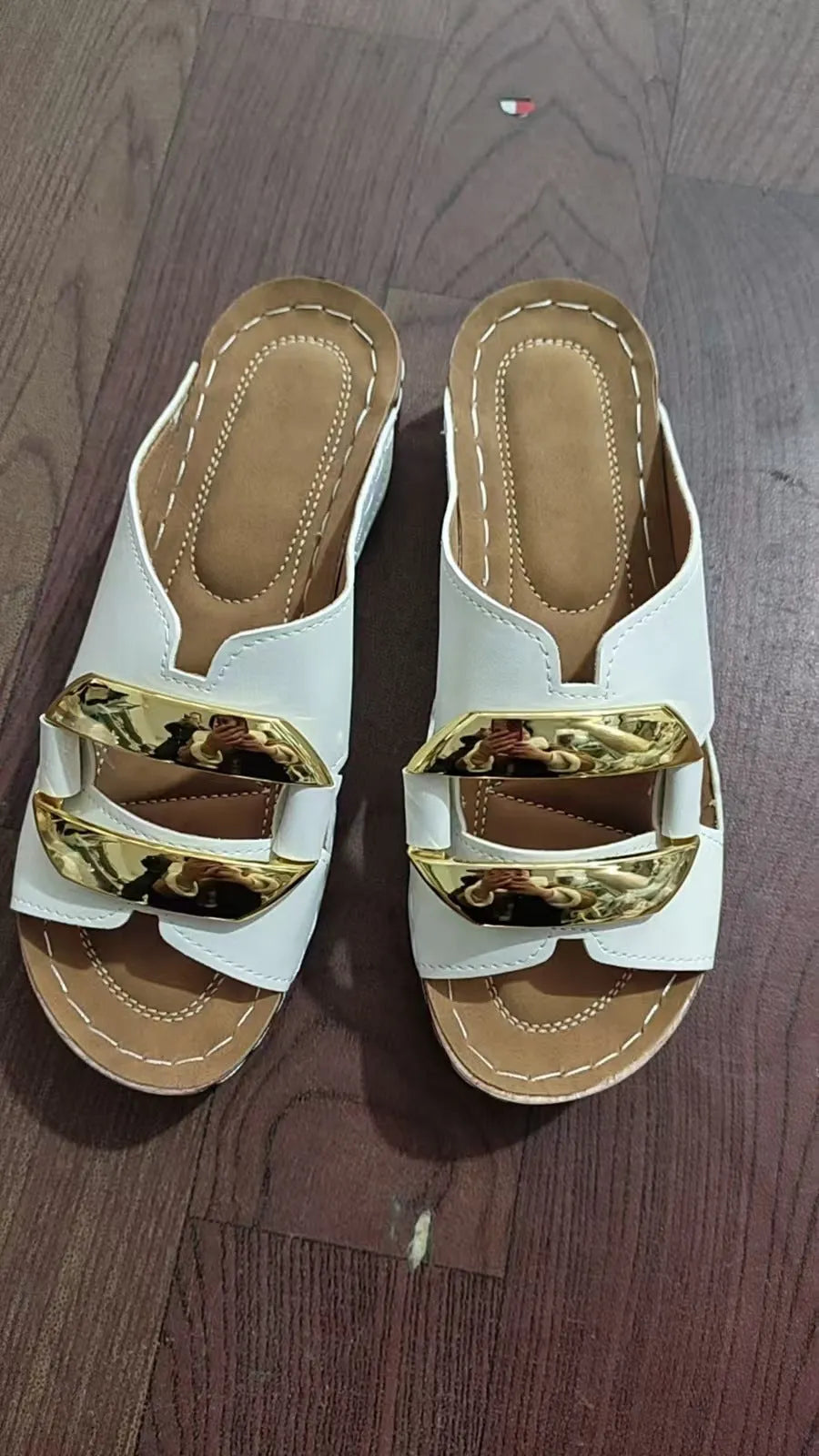 Women's Roman-style platform sandals in white, black, khaki, and sea blue with metal accent on rubber sole.