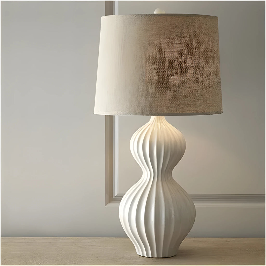 American country style ceramic table lamp with a white fabric shade, shown on a wooden table.