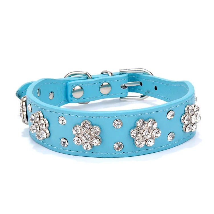 Black PU leather dog collar with sparkling rhinestone flower studs and a metal D-ring.