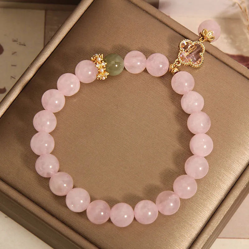 Pink crystal bracelet for women with a four-leaf clover pendant, alloy inlay, and rhinestones.