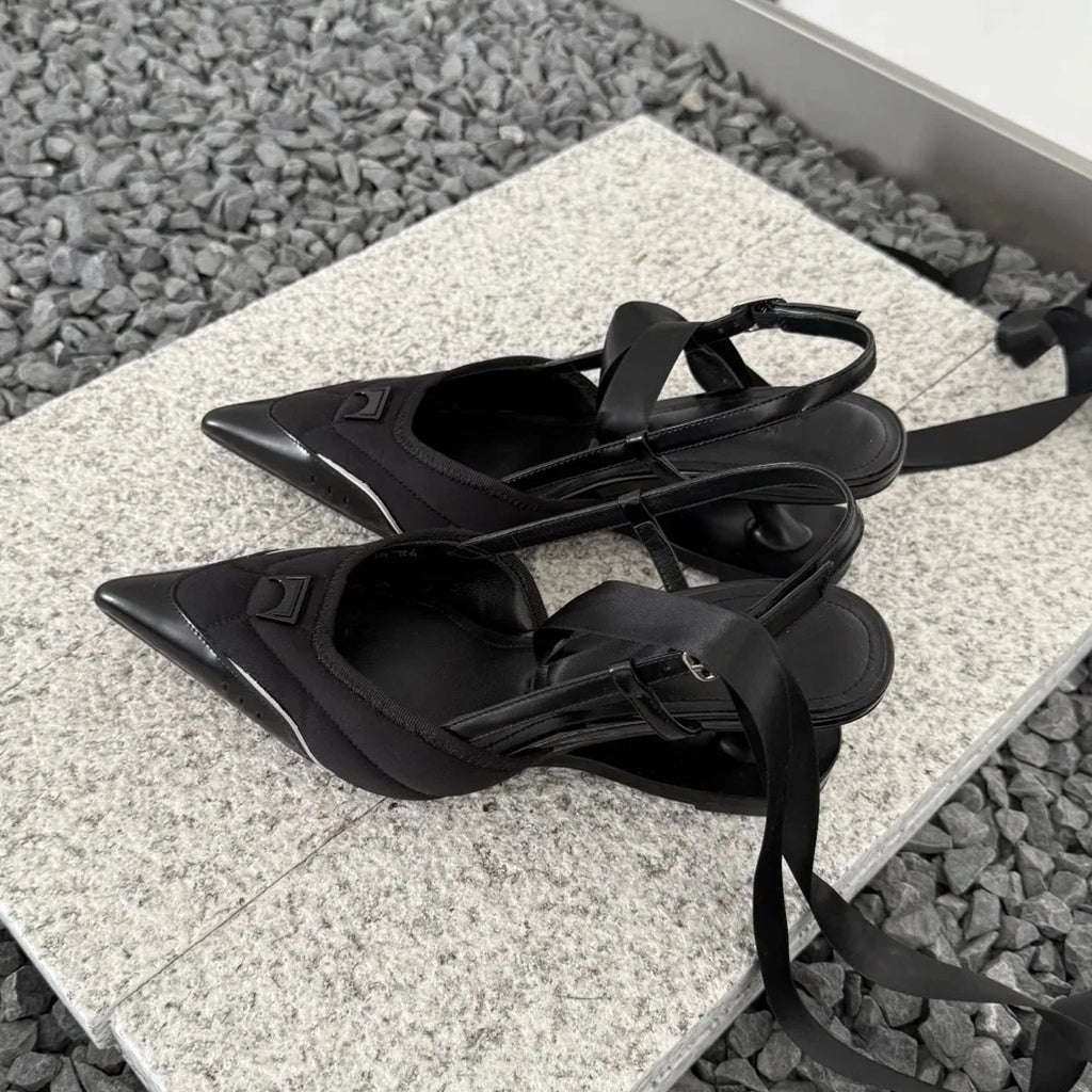 Women's black lace-up high heels with a special-shaped root design on a white background.