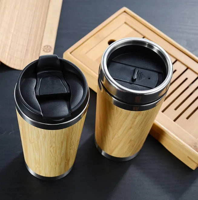 Bamboo coffee cup with double wall insulation, leak-proof lid, and non-slip foam pad on a table