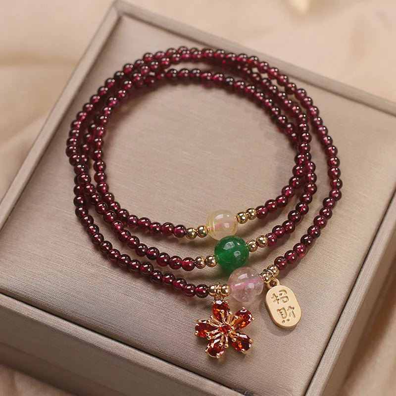 Women's natural crystal bracelet in pomegranate red cherry blossom colour with sequin accents