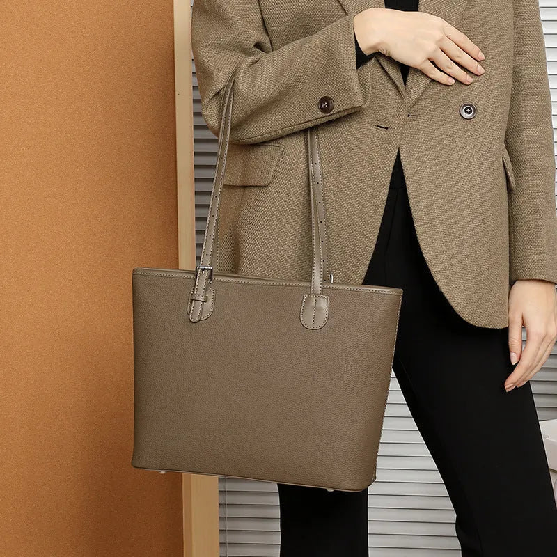 Genuine leather women's tote bag in retro style showing multiple compartments and horizontal suitcase shape