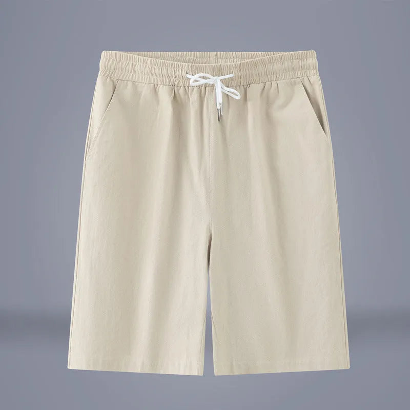 Man wearing loose-fit cotton linen cropped trousers in army green with a drawstring waist.