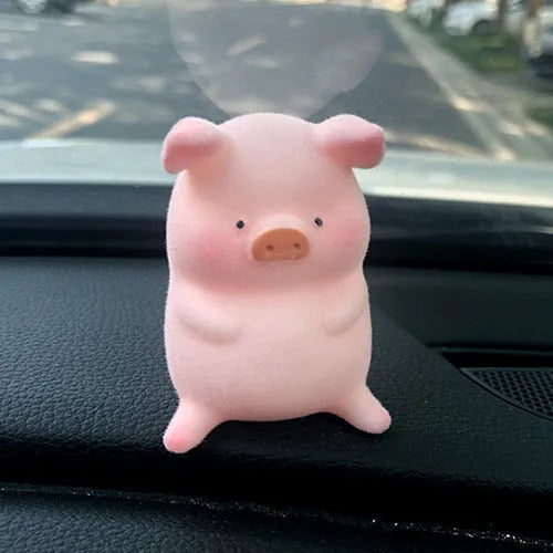 Glossy resin cartoon pig ornament for car dashboard decoration, shown in one of eight available character styles.