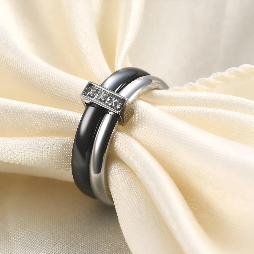 Close-up of a women's geometric ceramic ring with a 6mm wide band and glossy stitching detail, shown in a gold white electroplated finish.