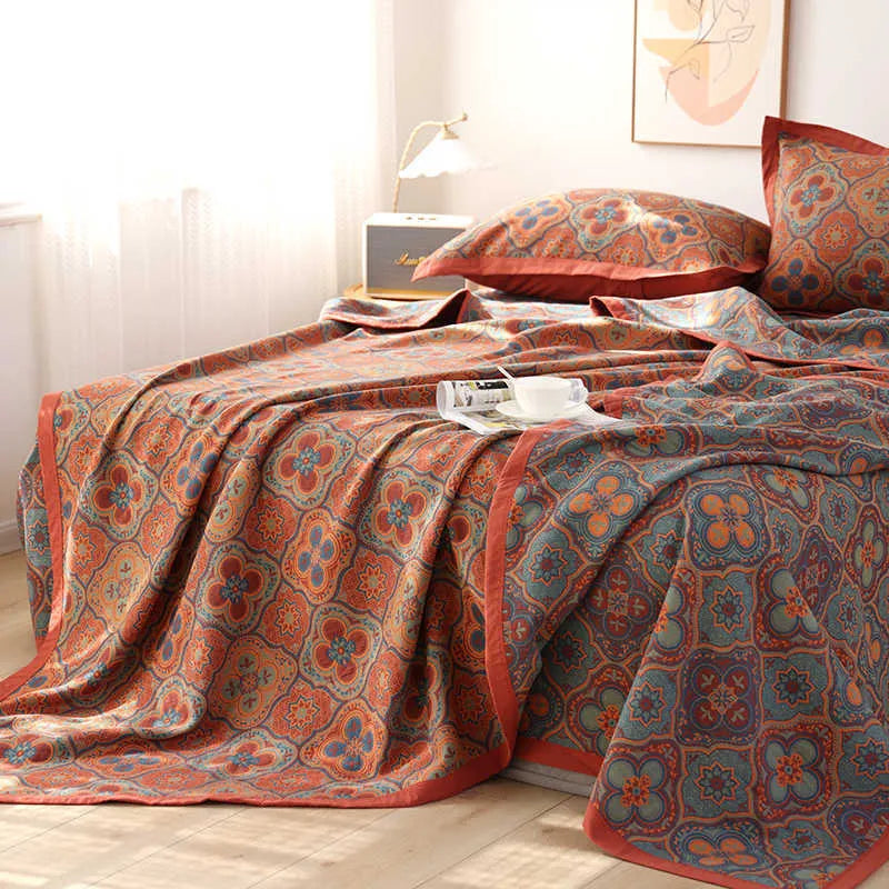 Three-piece cotton gauze bedding set with floral pattern showing blanket and two pillowcases