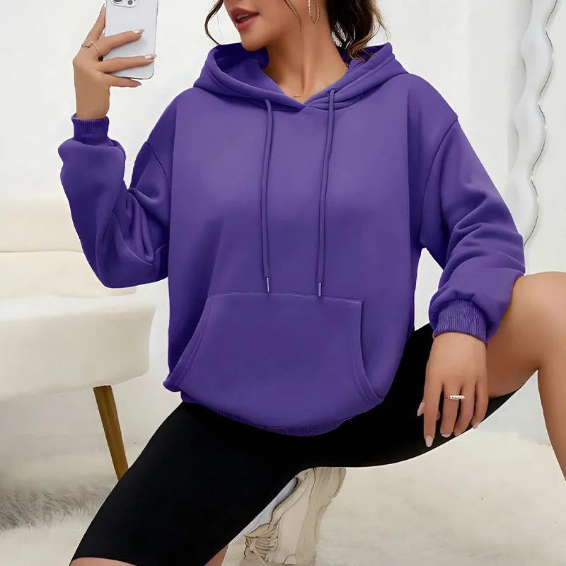 Women's loose grey hooded sweatshirt with a front pocket and drawstring.