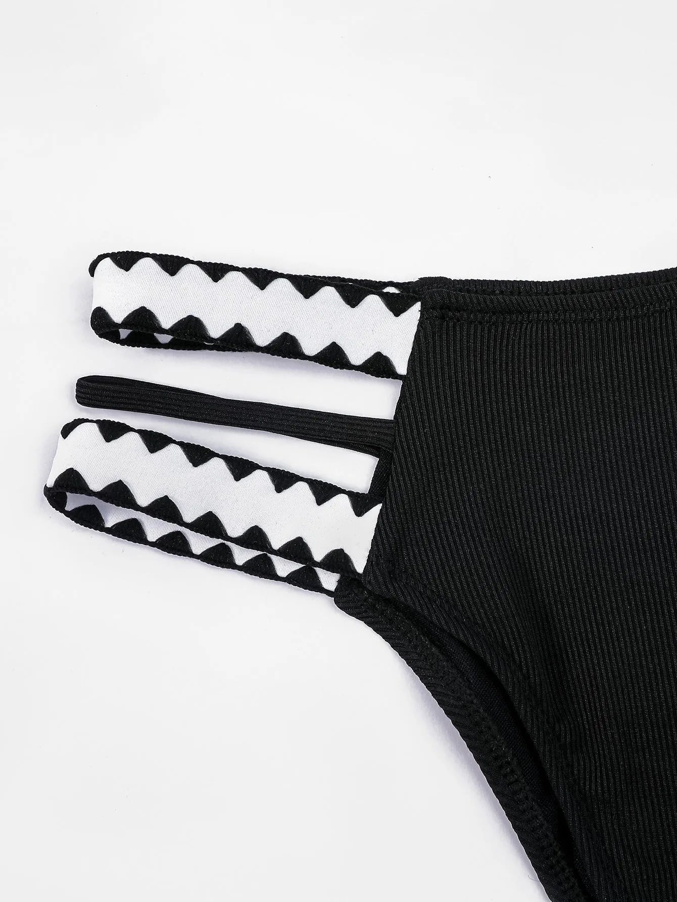 Black women's one-piece swimsuit with hollowed-out split design and briefs cut.