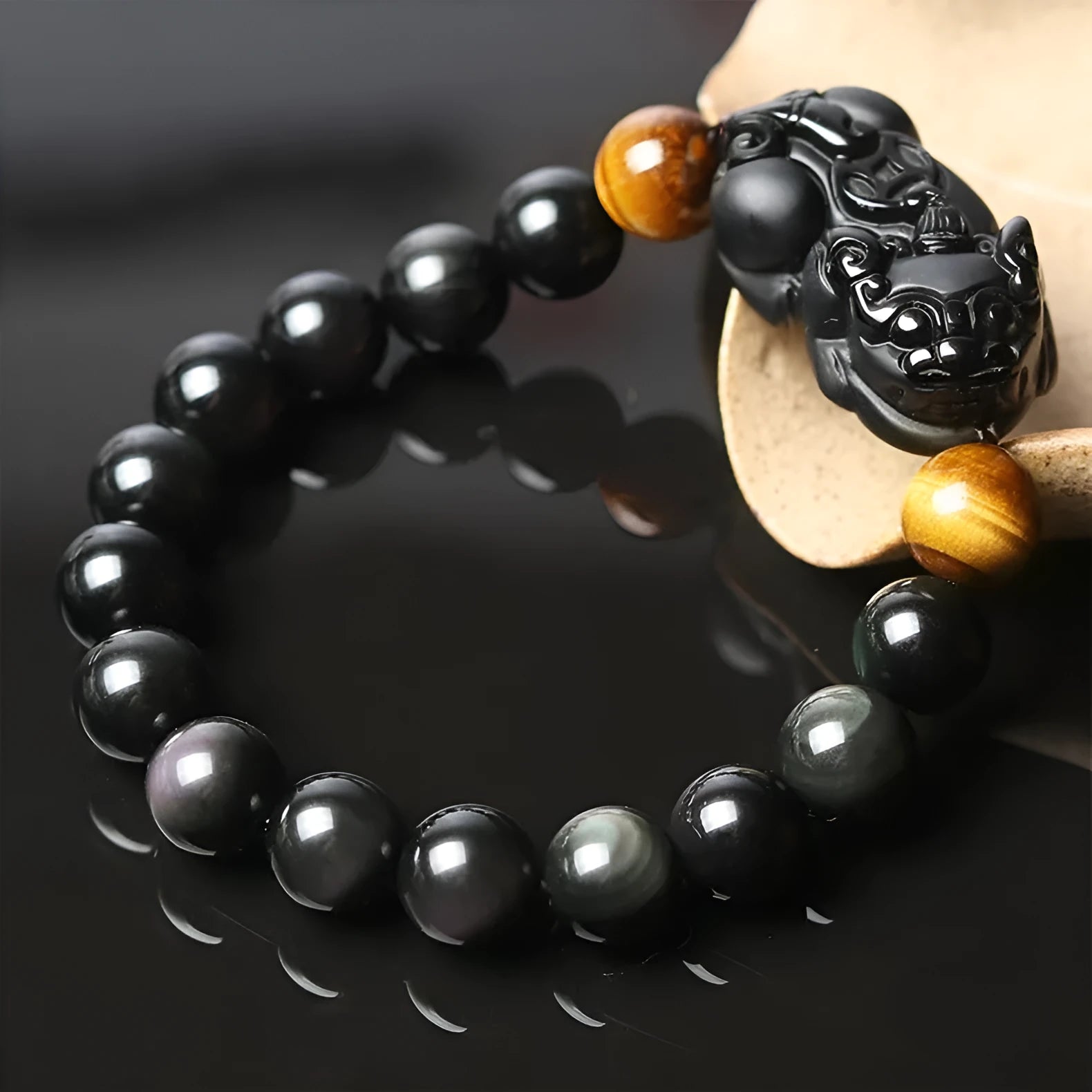 Black Mexico Gold Sheen Obsidian crystal bracelet with Pi Xiu charm, showing different bead size options.