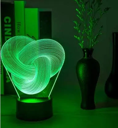 Twist abstract LED 3D night light in colour gradient mode on a wooden table with remote control