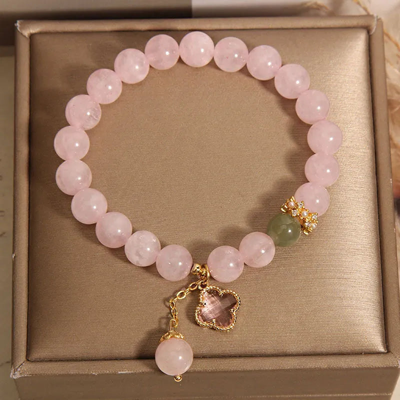 Pink crystal bracelet for women with a four-leaf clover pendant, alloy inlay, and rhinestones.