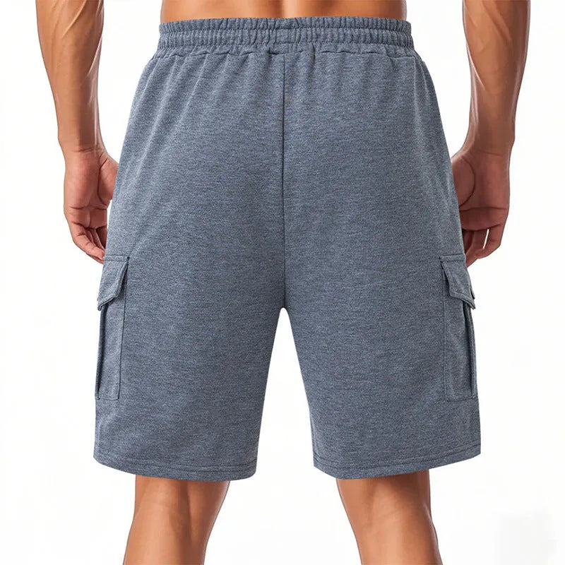 Light grey loose-fit sports cargo shorts made from terry fabric, showing multiple pockets and a casual silhouette.