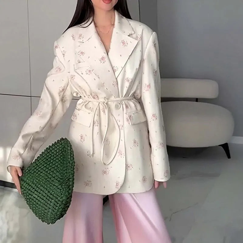 Women's printed polyester jacket with a lace-up collar detail, shown in a floral design.