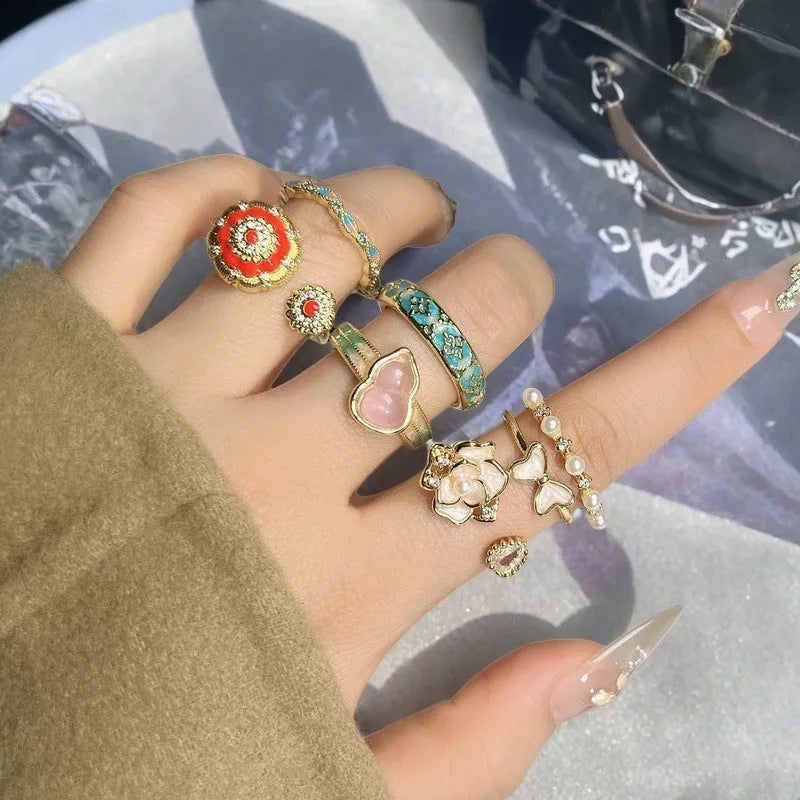 Close-up of an adjustable copper ring with a vintage oil-drip finish and a central gourd motif set with zircon stones.