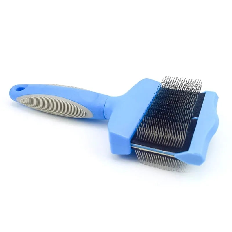 Blue dual-sided pet grooming brush with stainless steel pins on a wooden table.