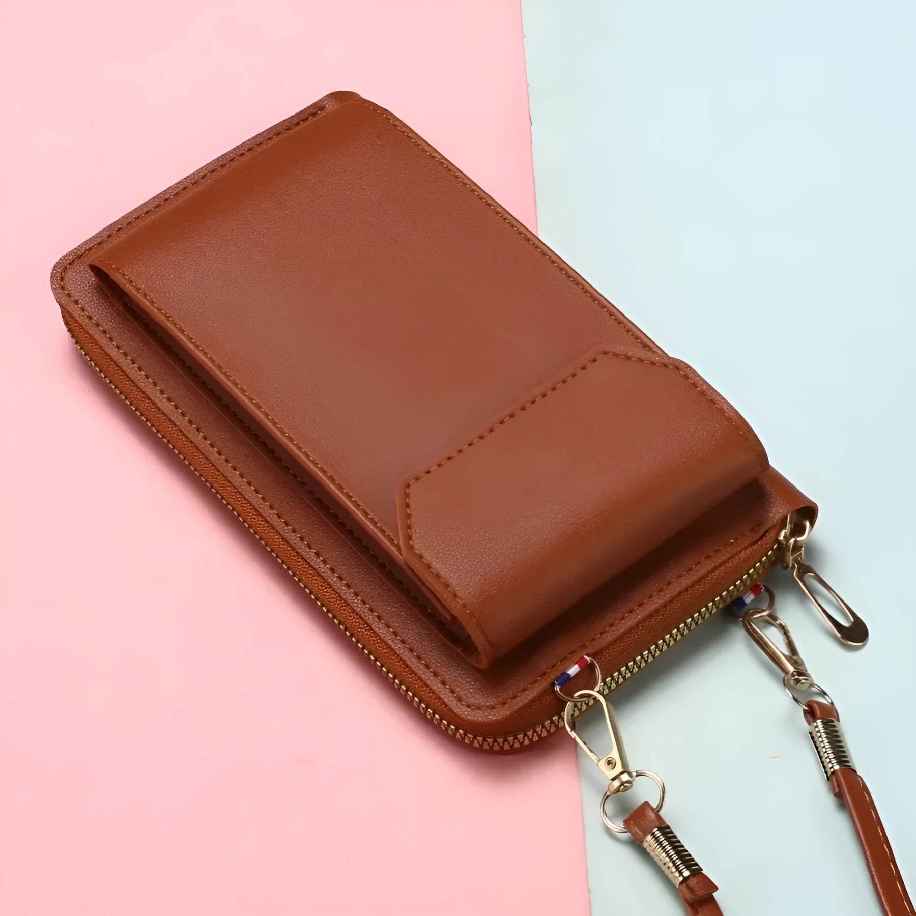 Mini crossbody phone bag for women in black PU leather with adjustable strap and sewing thread detail.