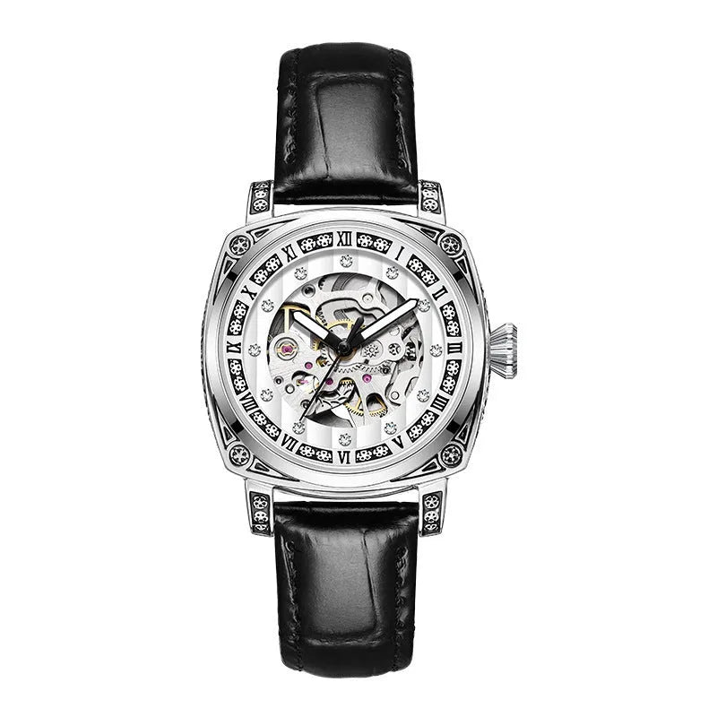 Mechanical watch with luminous hands and a black leather strap on a wrist.