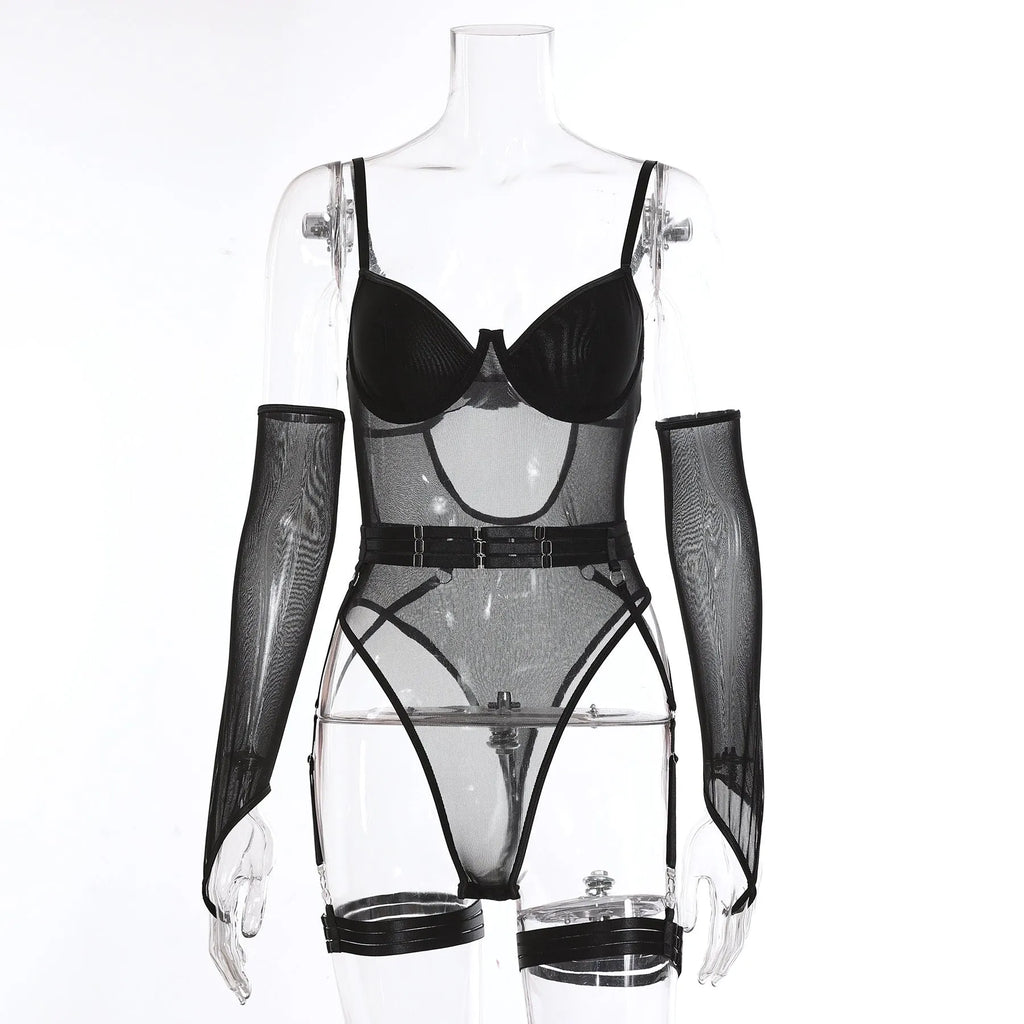 A woman wearing a black see-through mesh jumpsuit, a one-piece garment with long sleeves and legs.